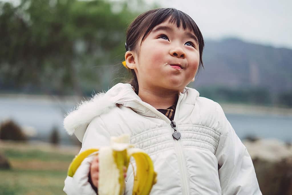 girl eating banana