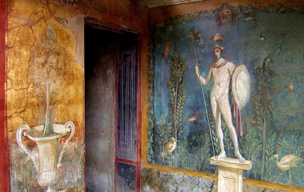  A fresco painting from Pompeii, Italy, depicting a figure with a spear and shield standing on a pedestal in front of a blue background with various animals and plants.