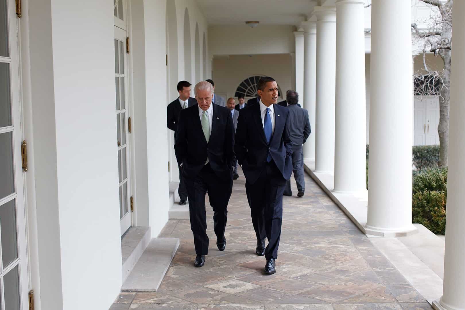 Obama and Biden walking together in the White House in 2009.