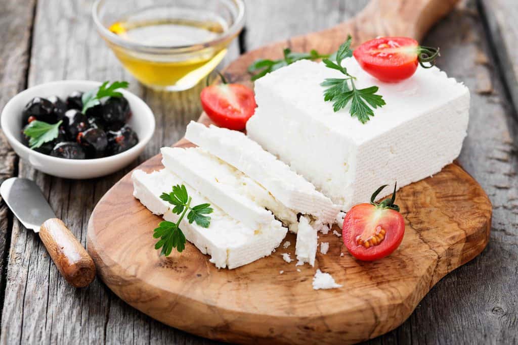 Sliced Feta cheese with herbs and olive oil