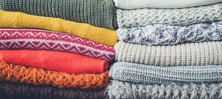 Pile of knitted woolen sweaters