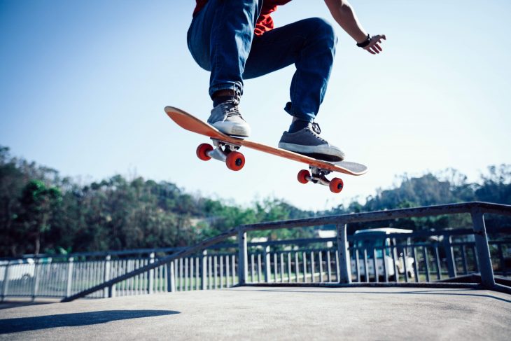 Skateboarder skateboarding at skatepark ramp