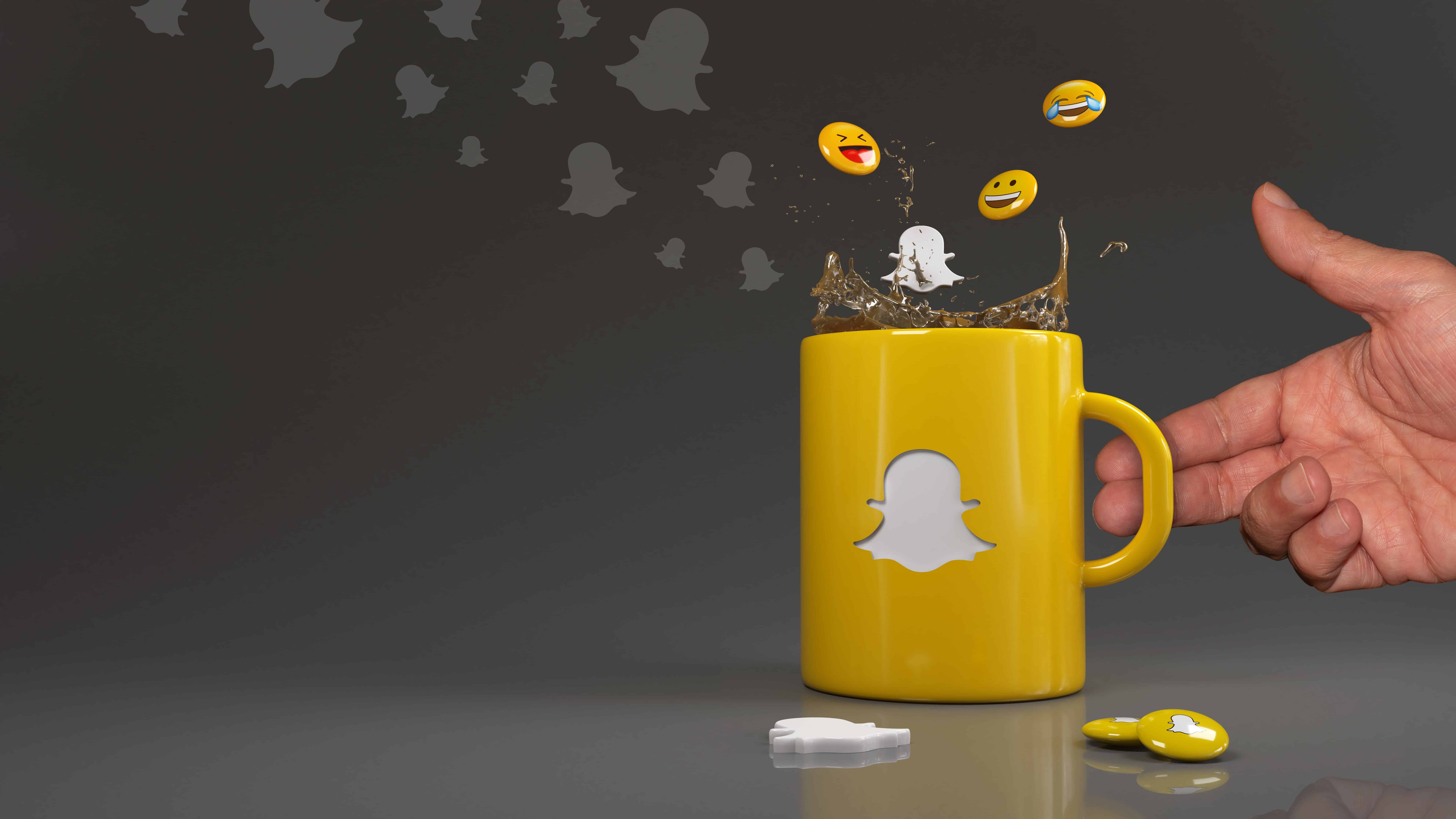 emojis falling into a yellow mug with the Snapchat logo