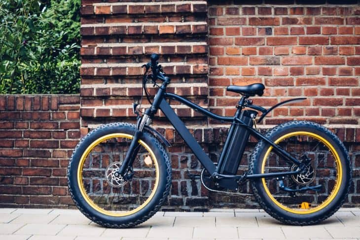 City electric bicycle near a brick wall