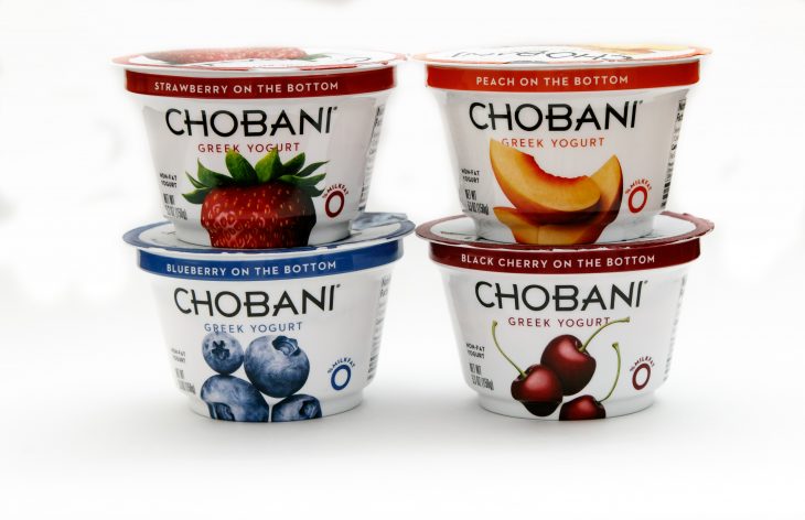 Four containers of Chobani greek yogurt of different flavors