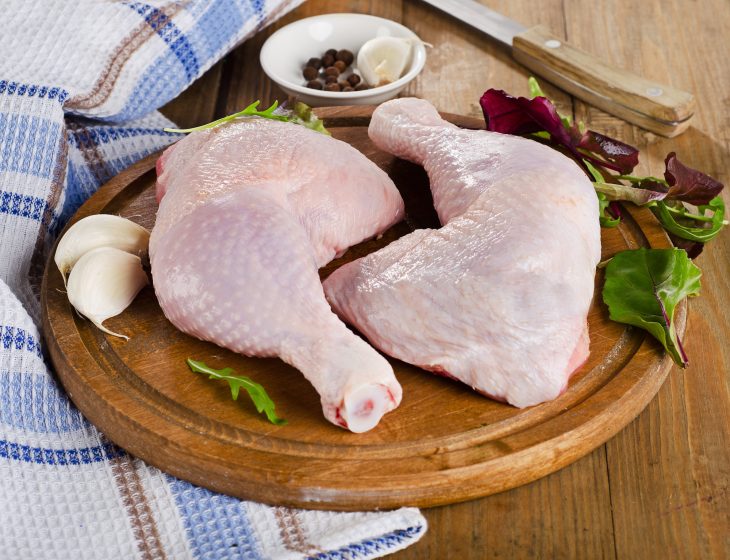 Fresh raw chicken legs on a cutting board