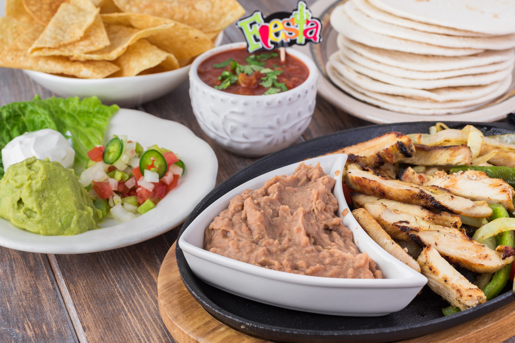 Mexican food. Chicken fajitas and refried beans
