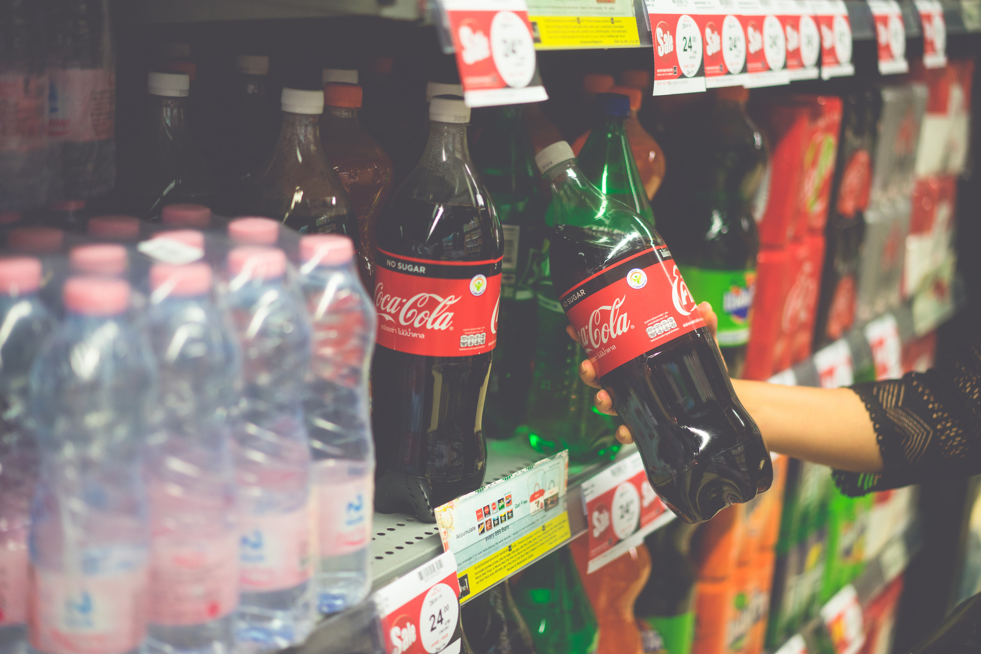 Woman hand choosing Coca cola coke zero cold soft drink