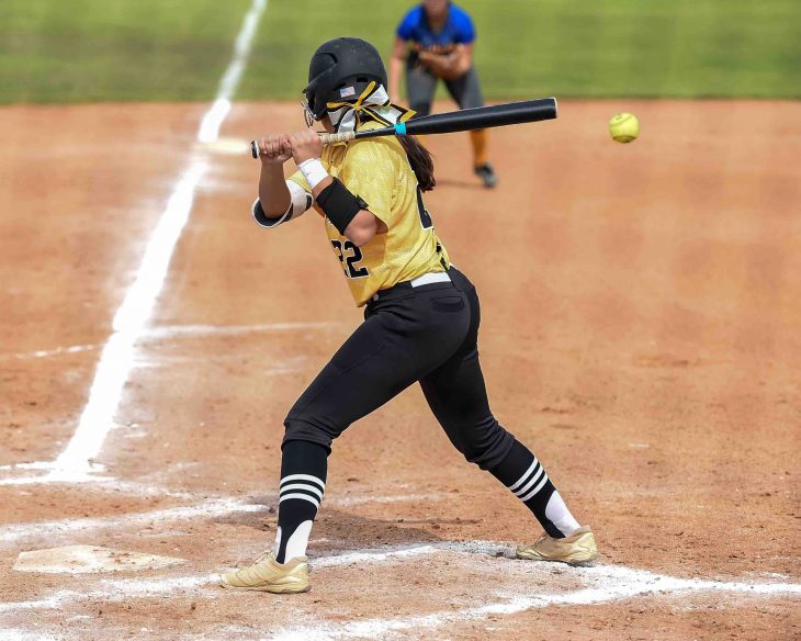 Girls in action playing in a softball game