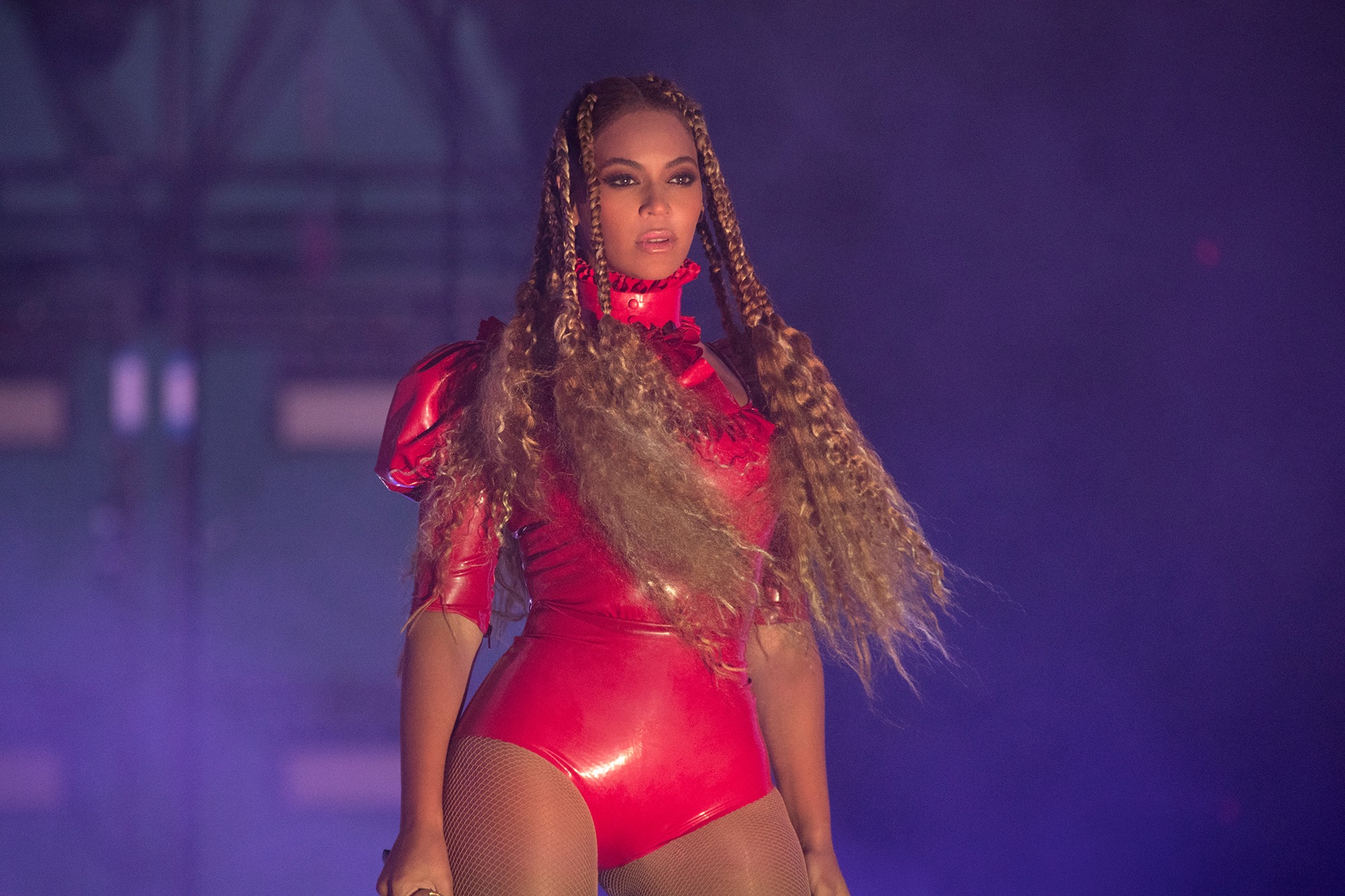 beyonce in red body suit lookinf charismatic on stage
