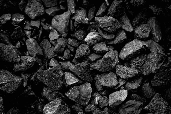 A heap of black natural coal, photo of coal mine background, texture