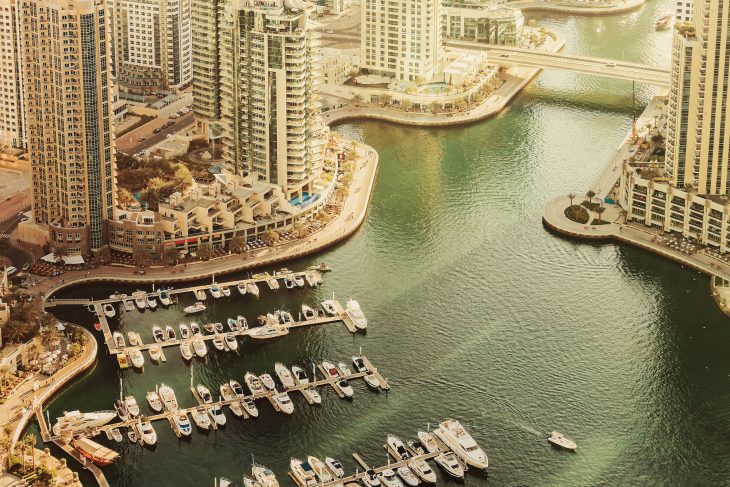 Scenic view over Dubai Marina harbor with boats and yachts