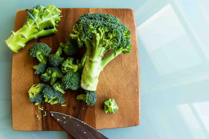 flat lay broccoli on chopping board on knife