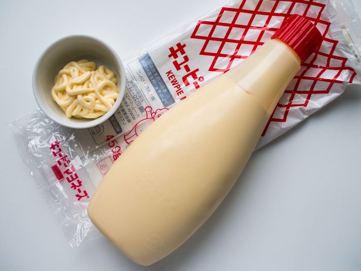 flat lay shot of kewpie mayonnaise bottle and a condiment cup