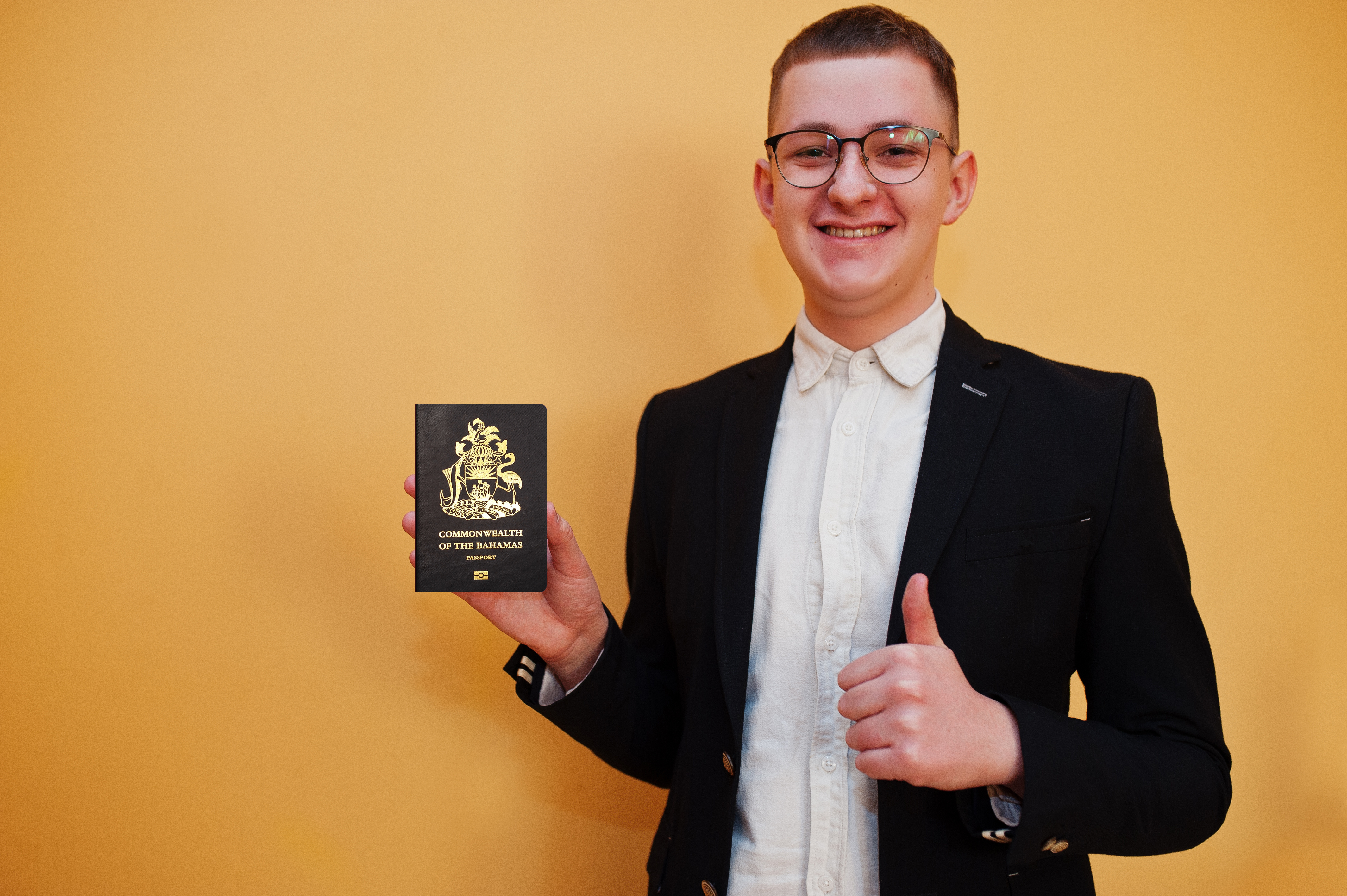 man holding Commonwealth of The Bahamas passport