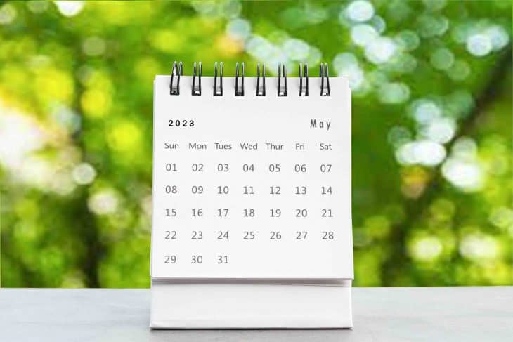 may 2023 desk calendar for planners and reminders on a black table on the natural background.