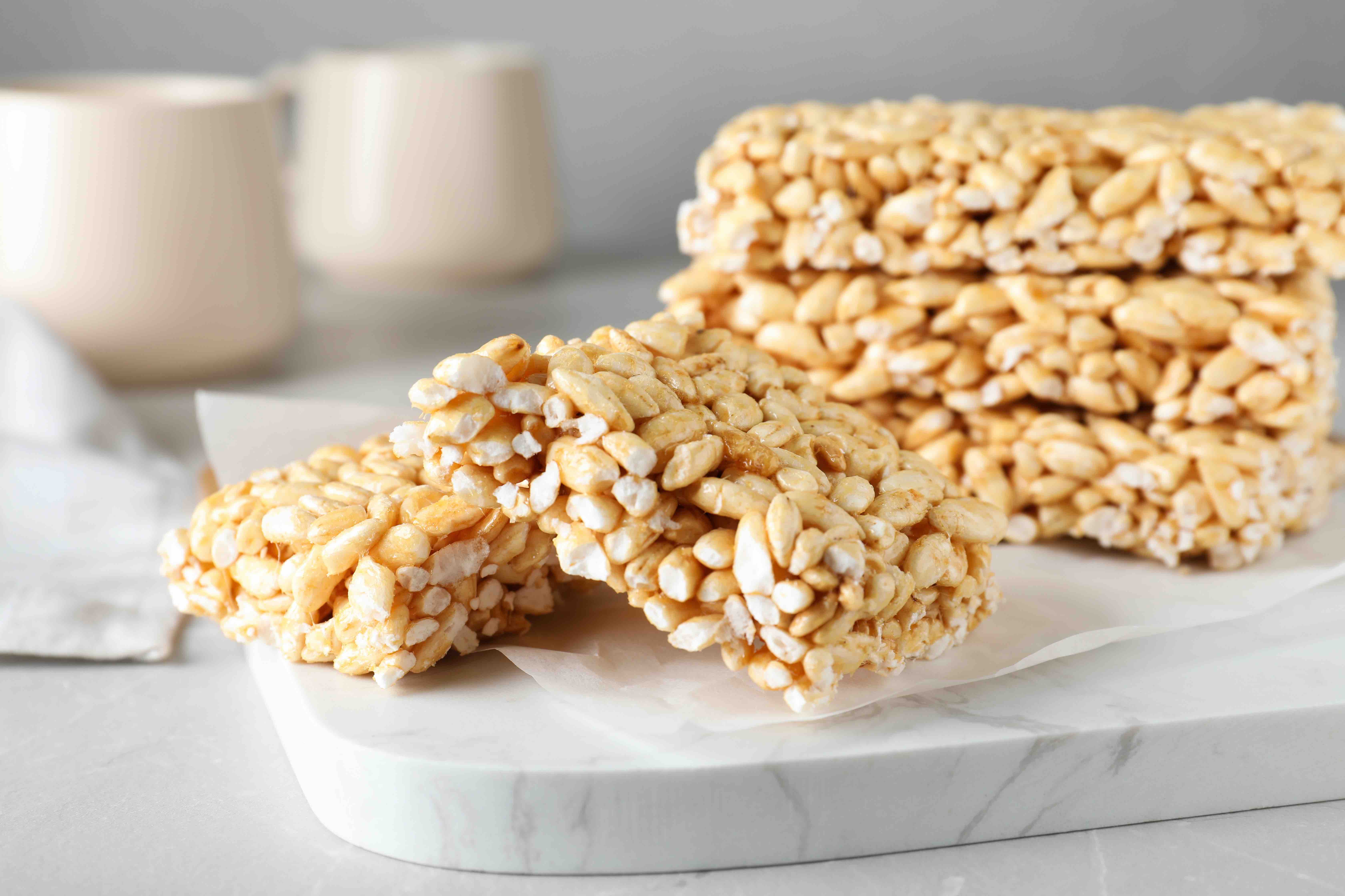 Delicious rice crispy treats on light grey table