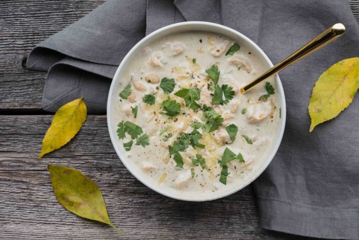 Flat lay shot of cream of chicken soup with coriander dressing