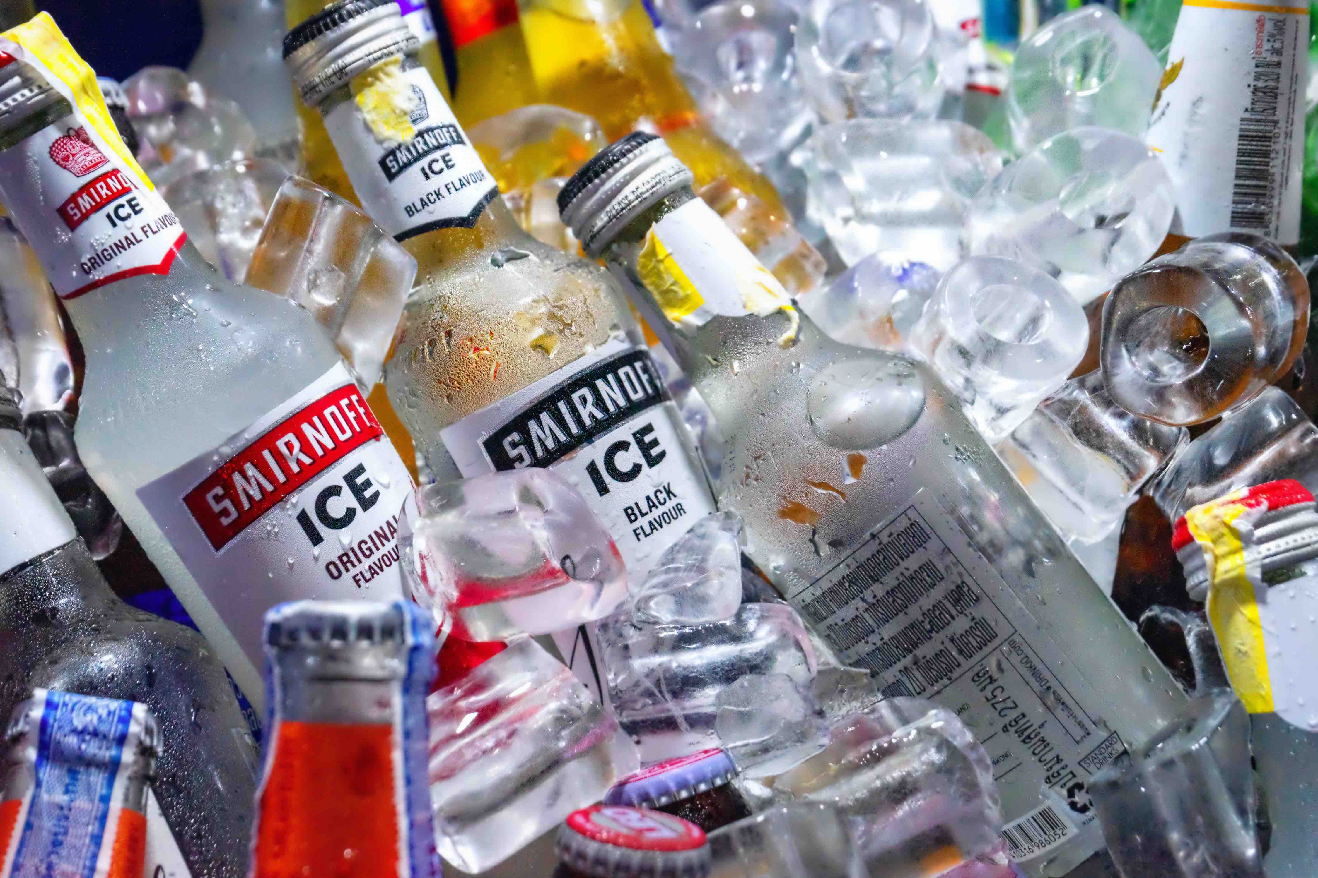 Bottles with alcohol in ice cubes