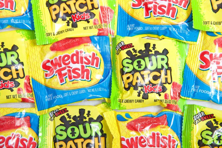 op view flat lay of Swedish Fish and Sour Patch kids brand treats, fun sized bags. Perfect for Halloween treat giving.