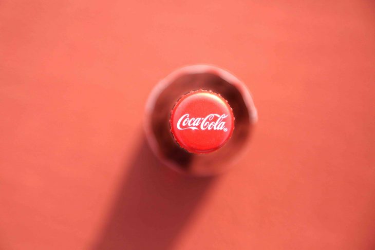 top view shot of coca cola bottle on red background