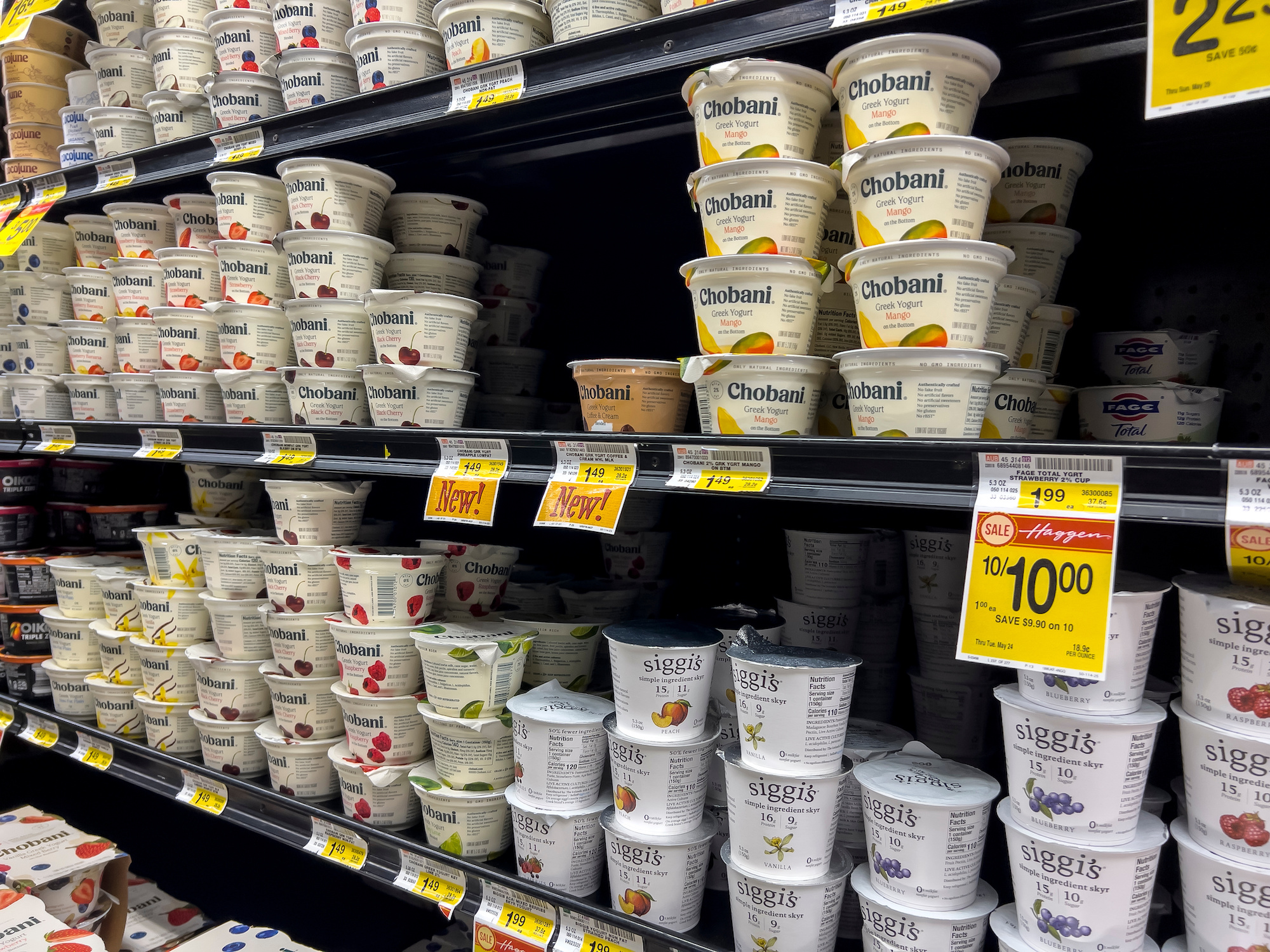 View of a variety of yoghurt for sale at supermarket