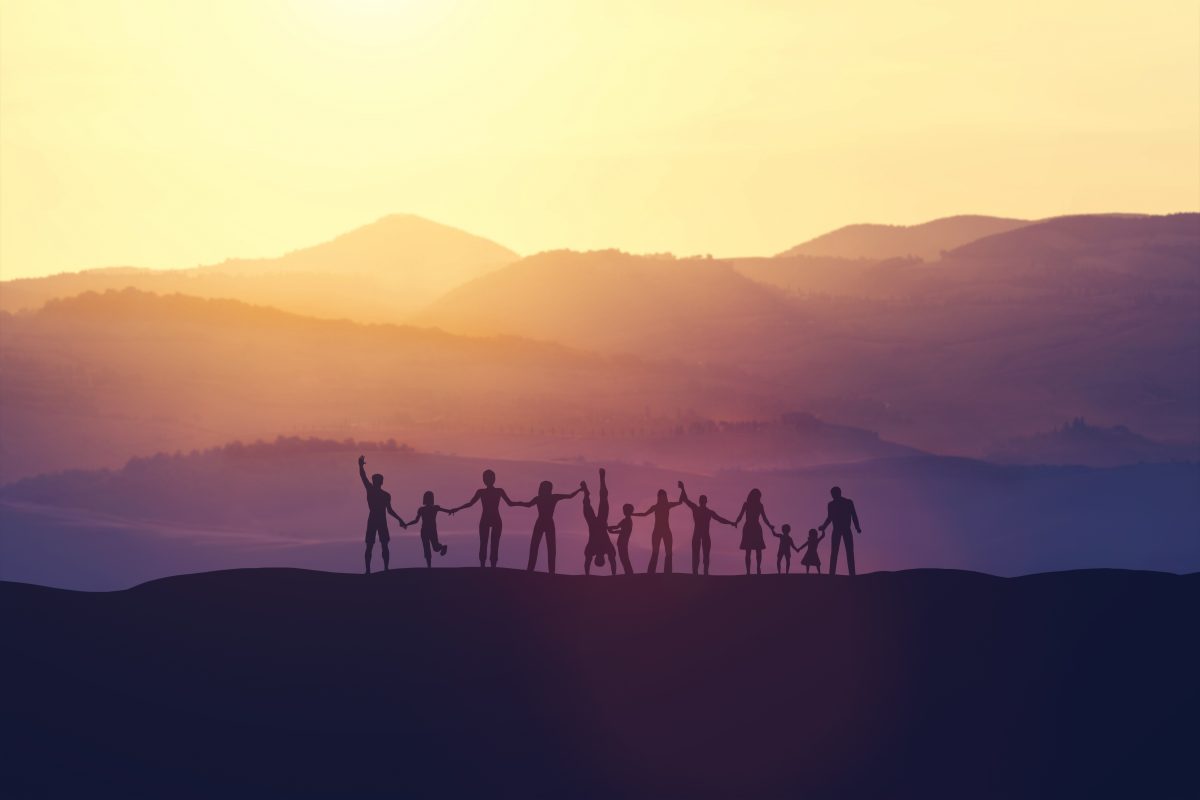 Group of happy people at sunset