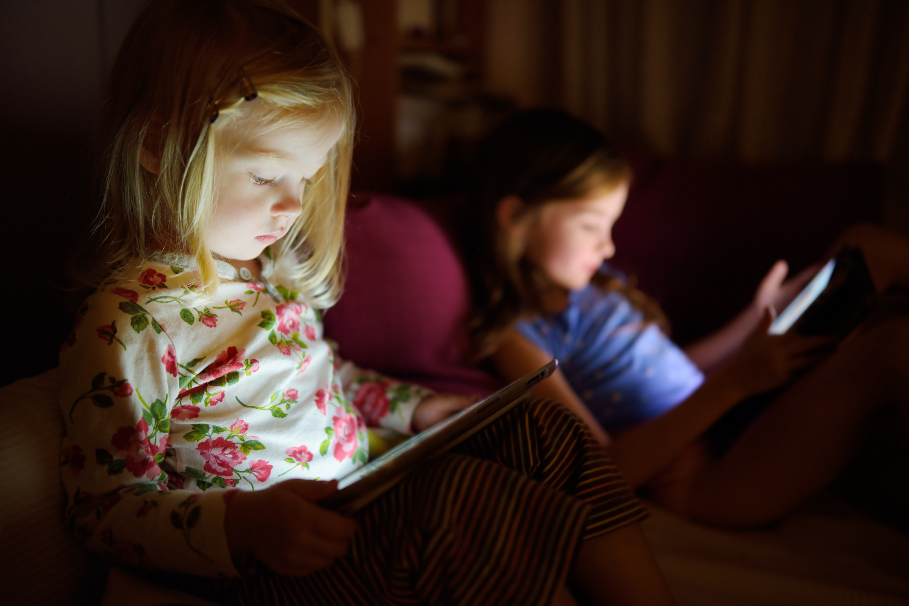 Two little sisters using digital tablet computer