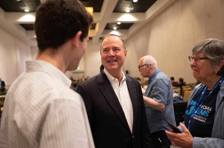 adam schiff smiling at conference