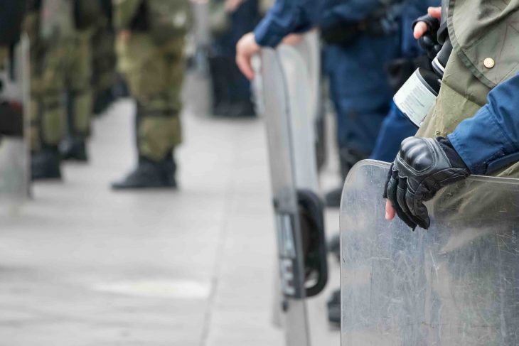 Male Riot police holding his shield with his hand, outdoors.