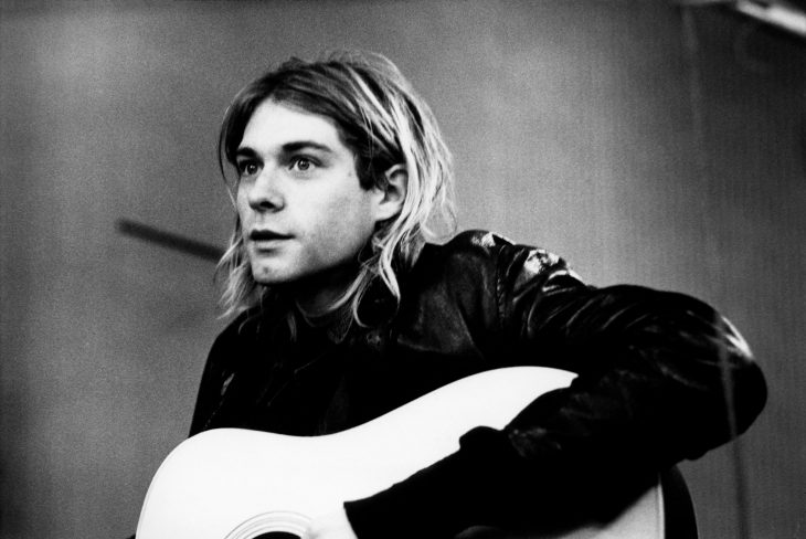 black and white image of kurt cobain with his guitar