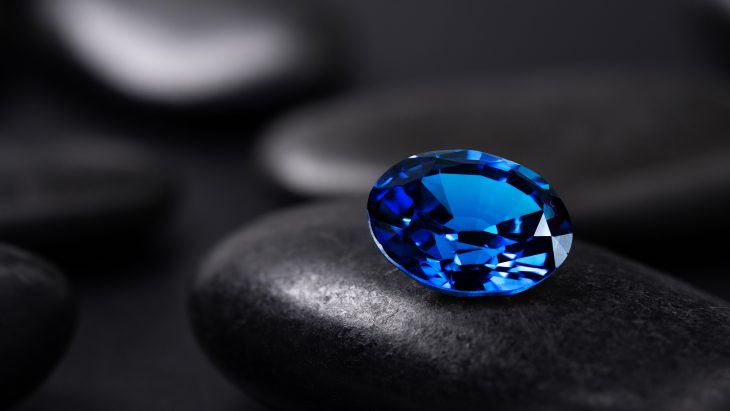 blue sapphire on black stone background