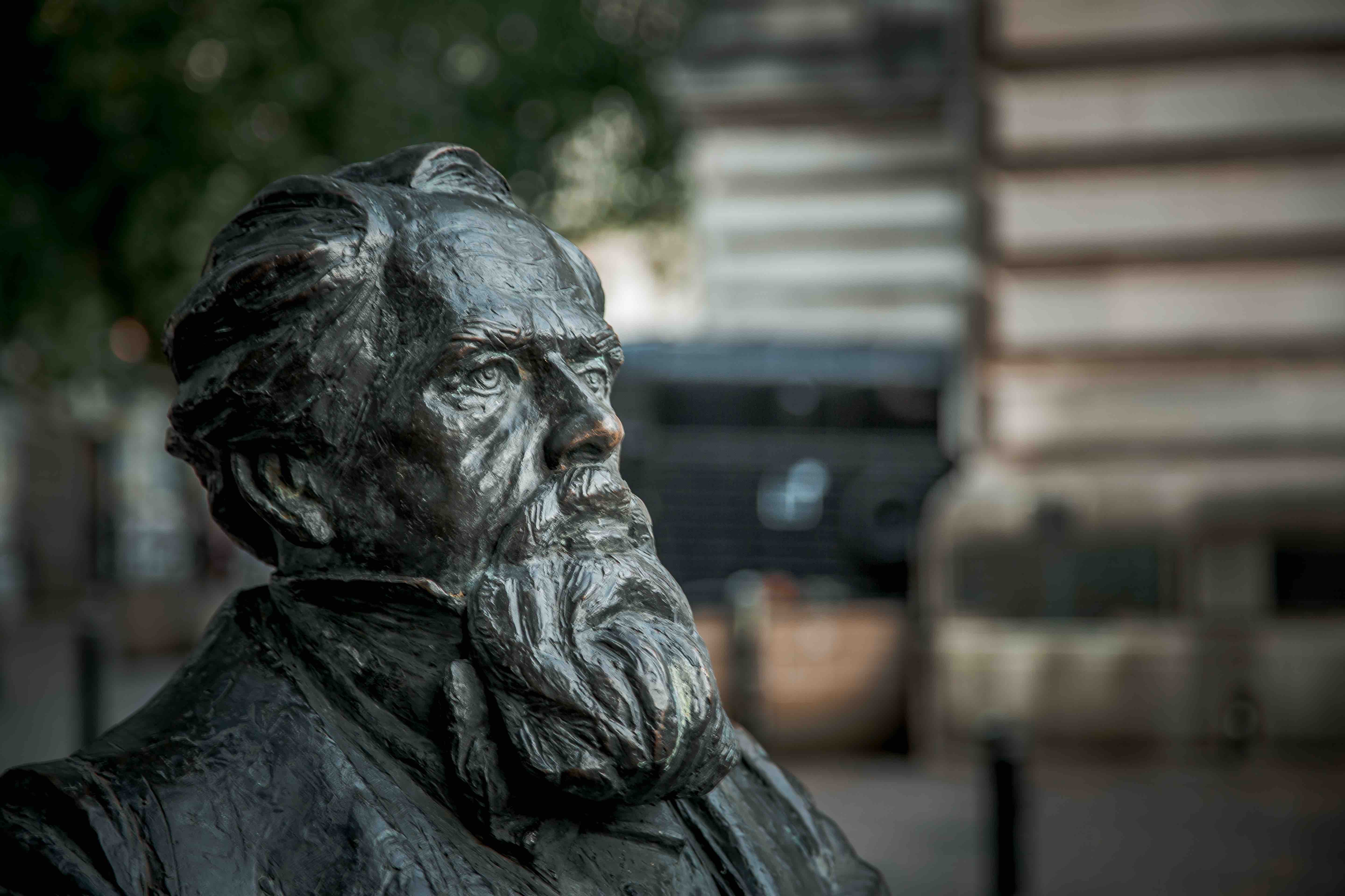 a close up of the face of Charles dickens, a statue in the center of Portsmouth UK