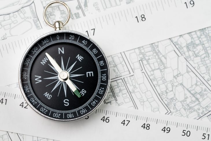 compass with measuring tape on transportation and building map