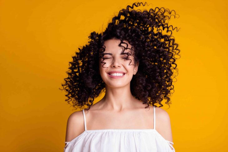 Photo of funky young girl having fun closed eyes toothy smile wear white blouse isolated yellow color background