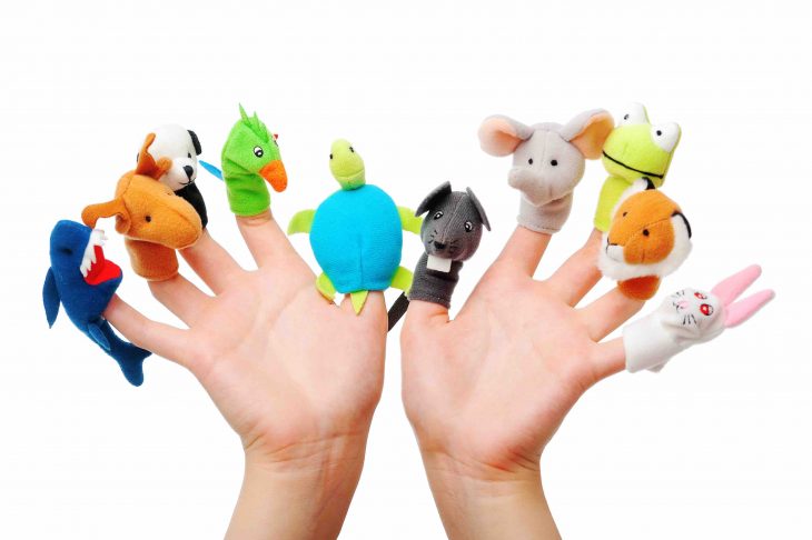 Female hand wearing 10 finger puppets