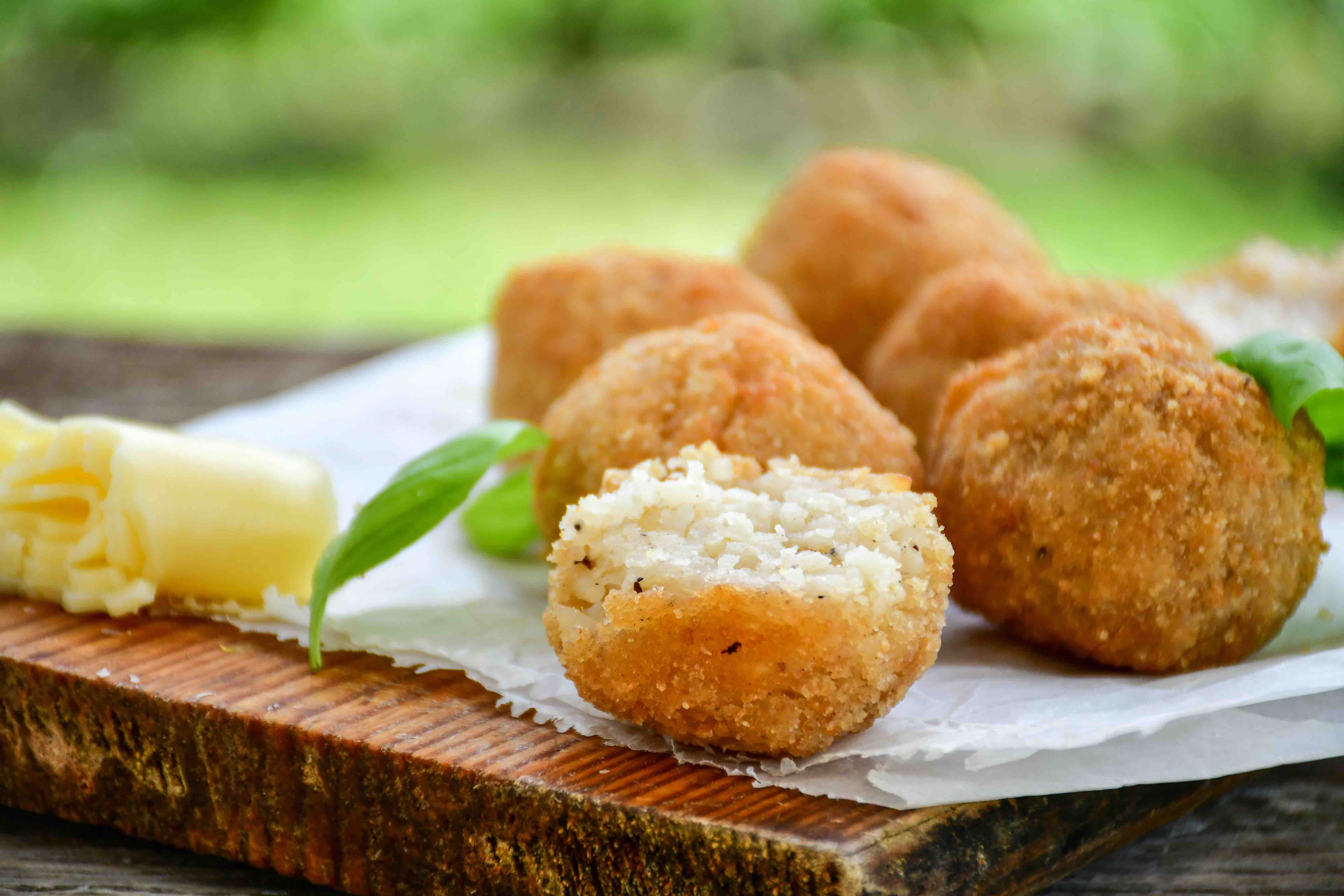 Italian arancini Cacio e pepe. Home-made rice balls with mozzarella cheese, parsley, lemon, and parmesan cheese.