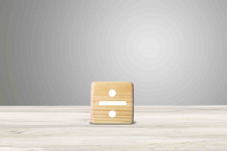 Division image on a wooden block stand on the desk