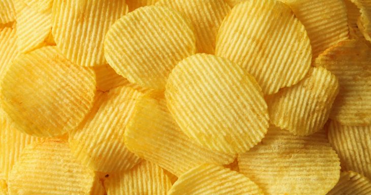 crispy potato chips snack texture background closeup top view