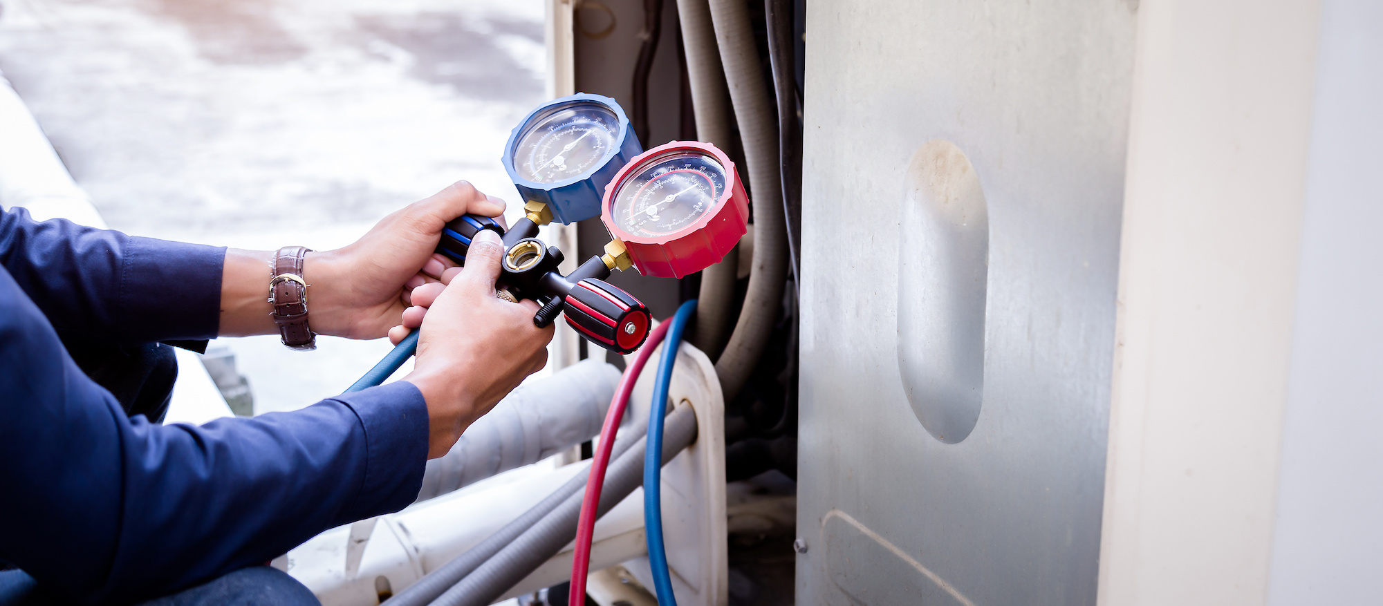 technician checking the refrigerant pressure