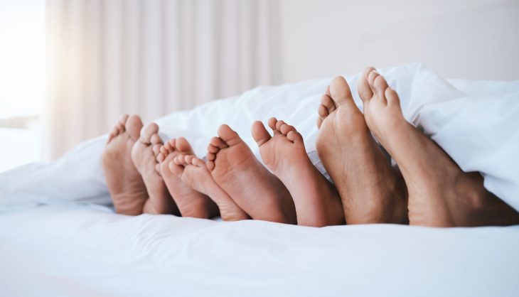 family feet in bed