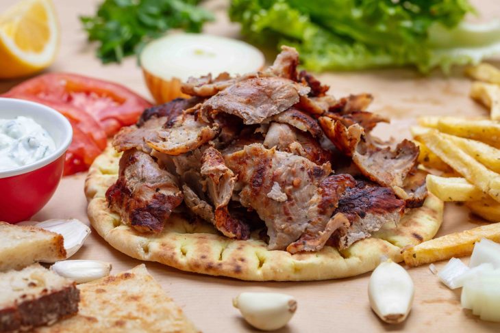 Shawarma, gyros pita. Traditional turkish, greek meat food on pita bread, closeup view