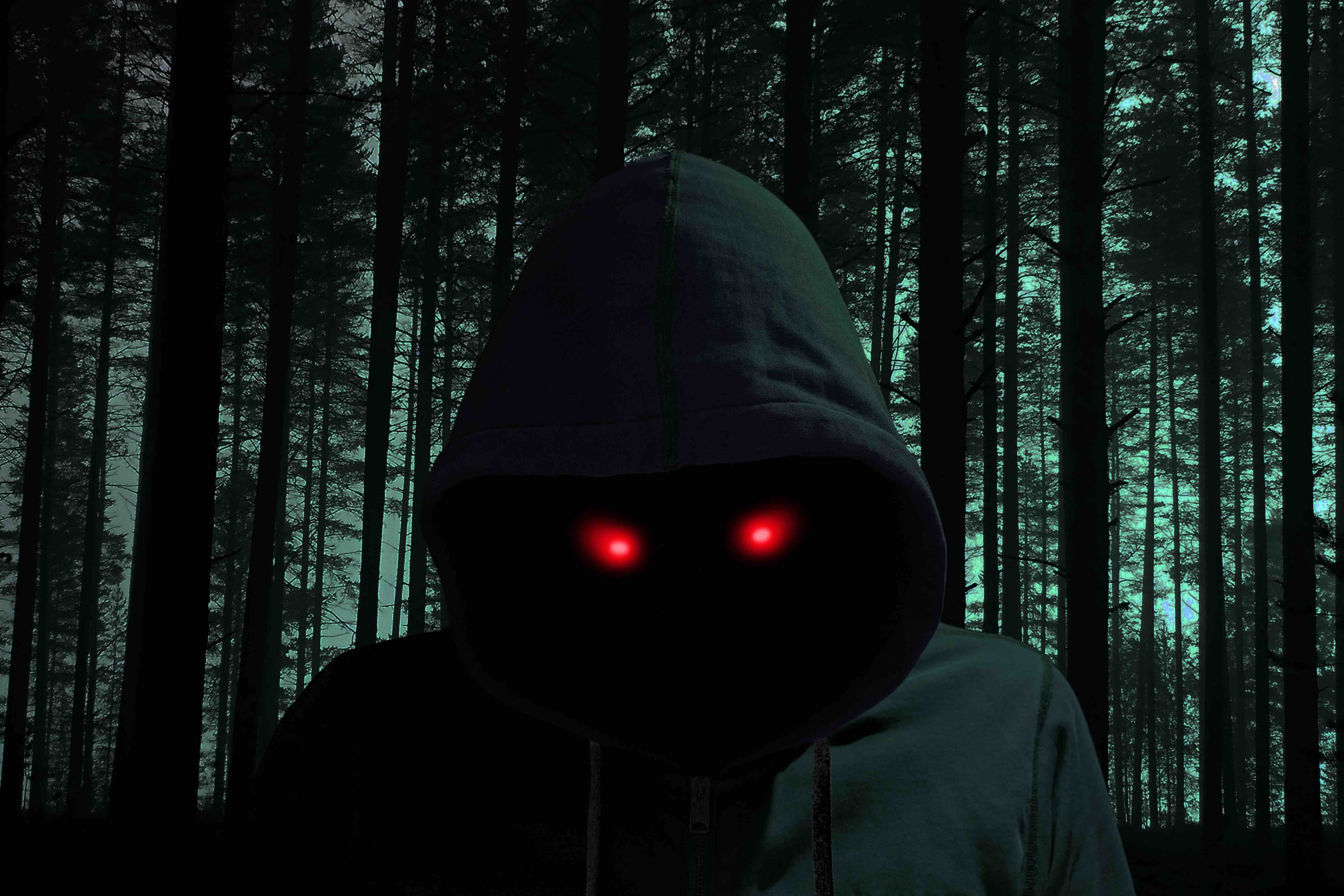 Dark man with hoodie in black forest red eyes