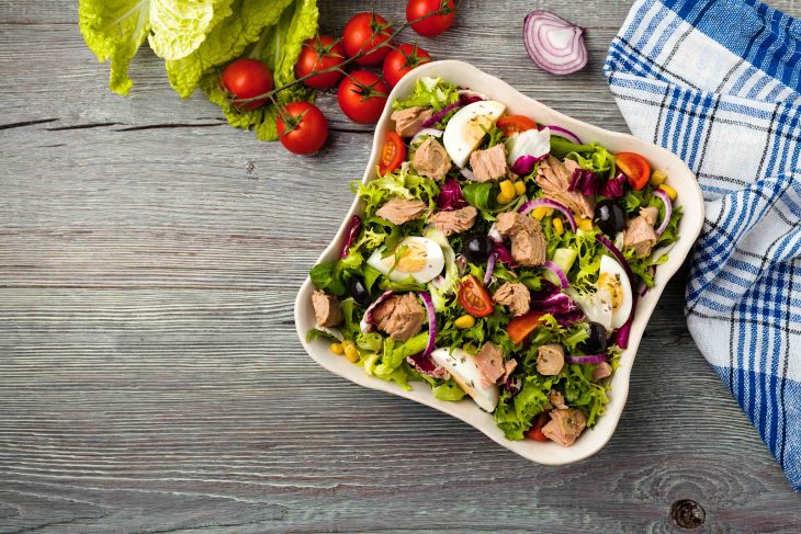 Tuna salad with lettuce, eggs and tomatoes.